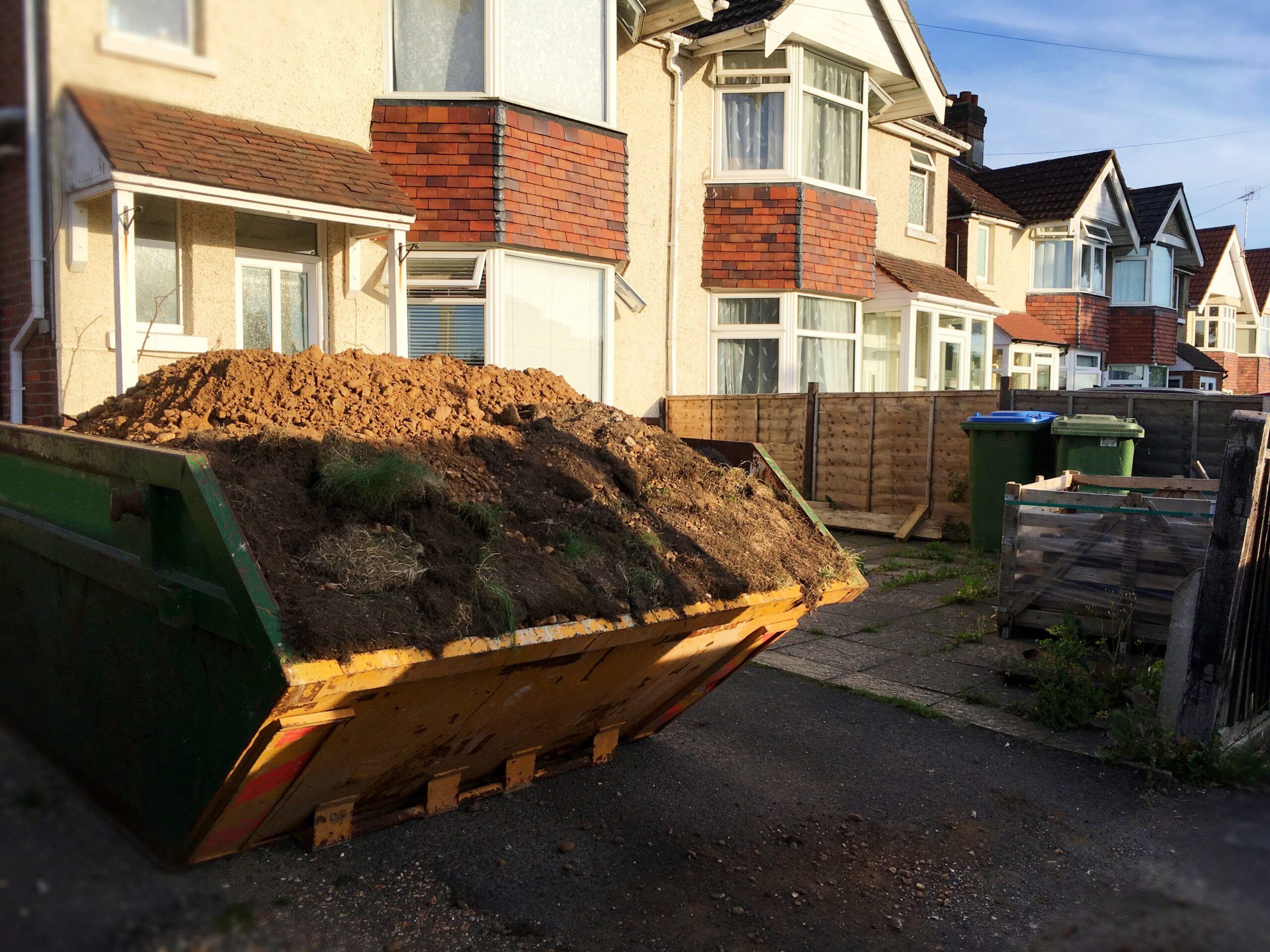 Closeup,Front,Part,Of,Industrial,Skip,Full,Of,Dirt,& Leigh Skip Hire